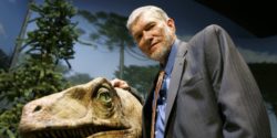 Ken Ham posing next to a dinosaur exhibit