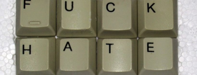 keyboard keys on a styrofoam background; the keys spell out "FUCK HATE"